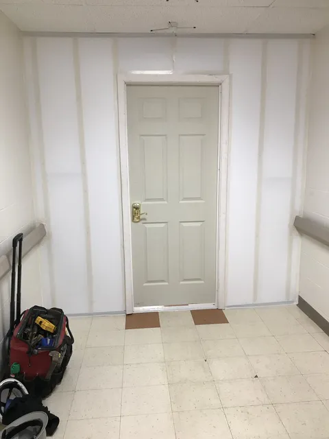 Drywall finishing around a doorway — In progress