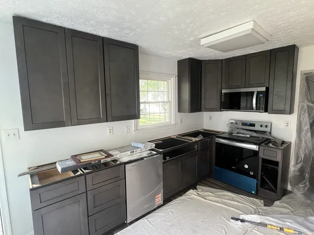 Dark kitchen cabinet installation — In progress