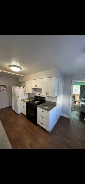 White kitchen and range wall — Installed cabinetry