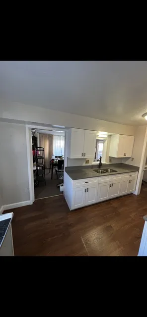 White kitchen and sink wall — Installed cabinetry